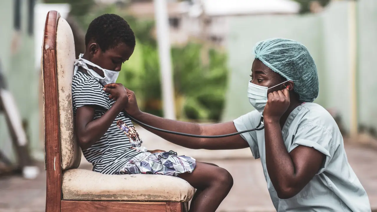 African-american boy getting a checkup by a doctor