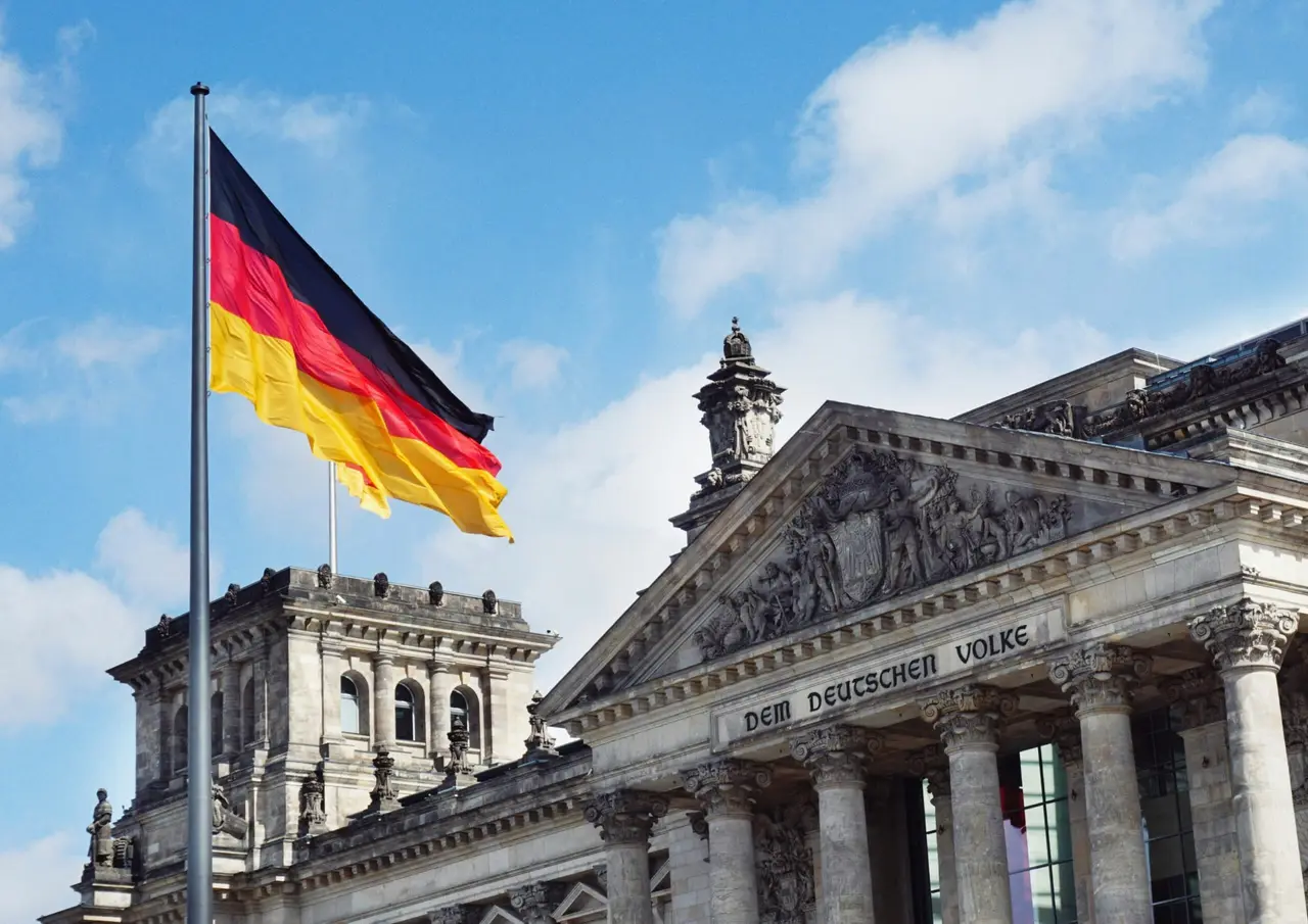 The German flag flying above the Reichstag building in Berlin, Germany