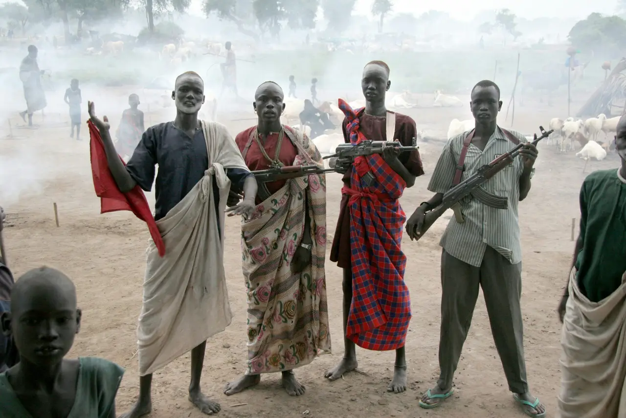Four men holding assault rifles