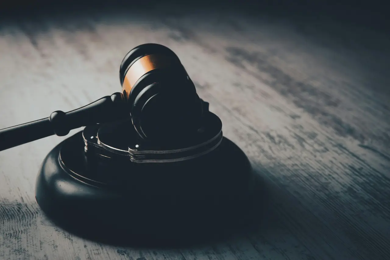 A judge's gavel on a wooden table