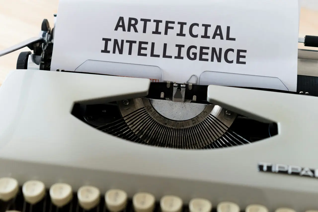 Typewriter with artificial intelligence written on a paper