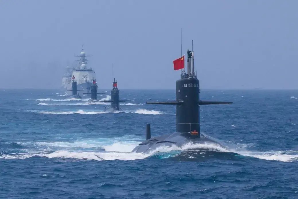 Chinese naval vessels, including submarines, sailing together at sea.